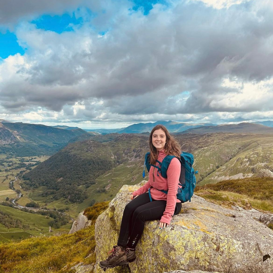 rach sat on a rock in the lake district